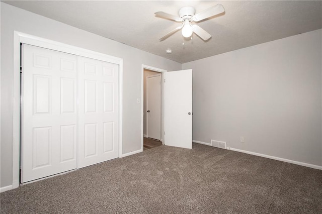 unfurnished bedroom featuring a closet, carpet, and ceiling fan