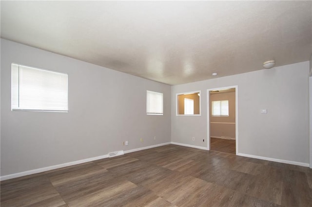 spare room with dark hardwood / wood-style floors