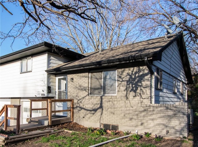 view of home's exterior featuring a wooden deck