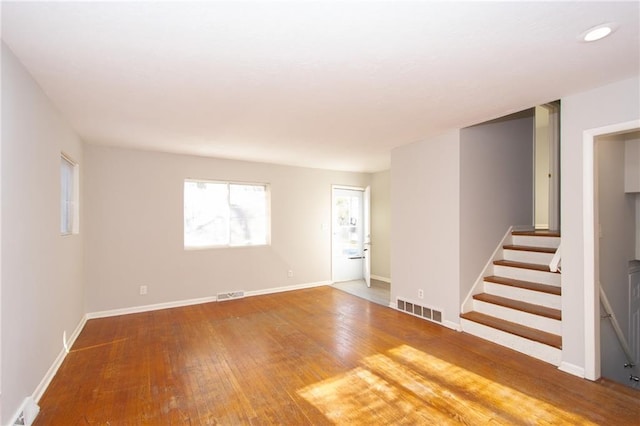 spare room featuring wood-type flooring