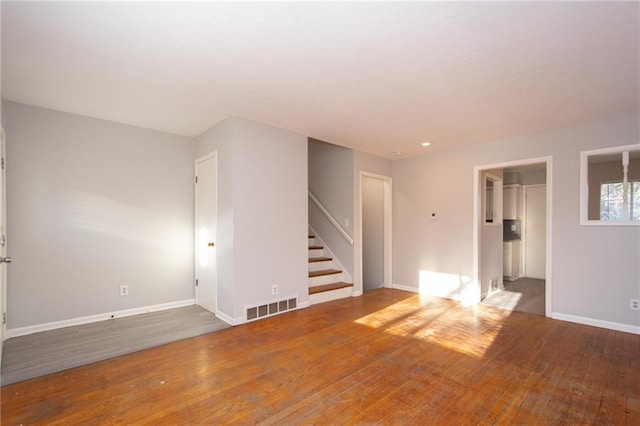 unfurnished room with hardwood / wood-style flooring