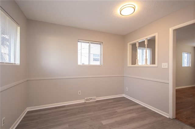 spare room with wood-type flooring and a textured ceiling