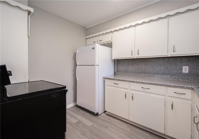 kitchen with white cabinets, light hardwood / wood-style floors, white fridge, and electric range