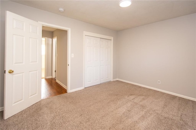 unfurnished bedroom featuring a closet and carpet flooring