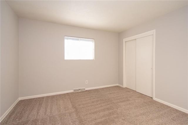 unfurnished bedroom featuring a closet and carpet