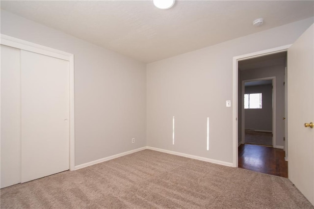 unfurnished bedroom featuring a closet and carpet