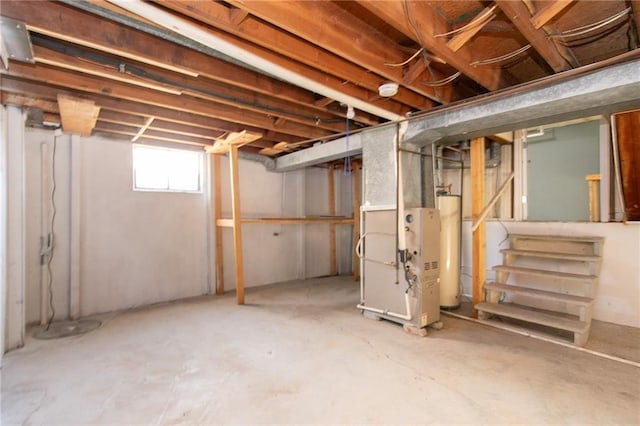 basement featuring gas water heater and heating unit