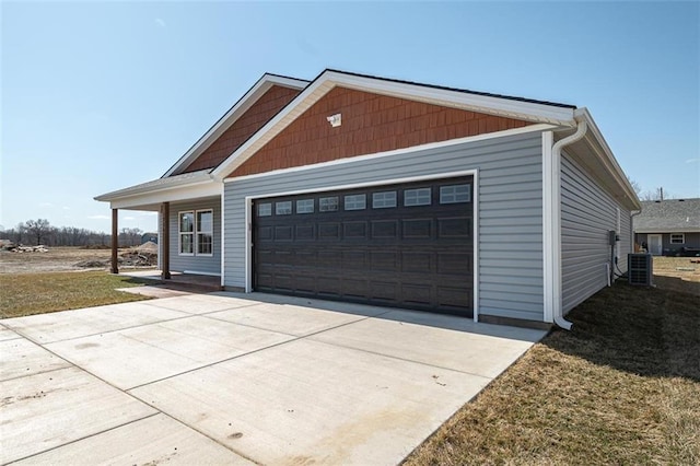 view of front facade with cooling unit and an attached garage