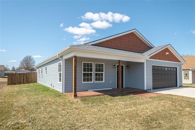 view of front facade with fence, driveway, a porch, an attached garage, and a front lawn