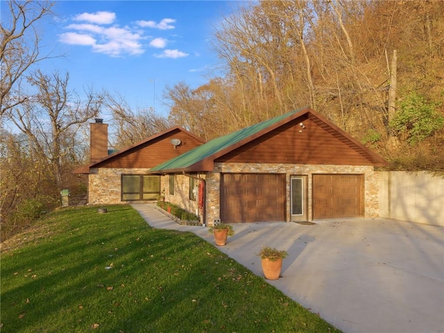 view of front of house featuring a garage and a front lawn