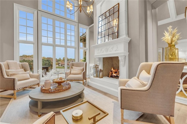 interior space featuring a towering ceiling, light hardwood / wood-style flooring, and a chandelier