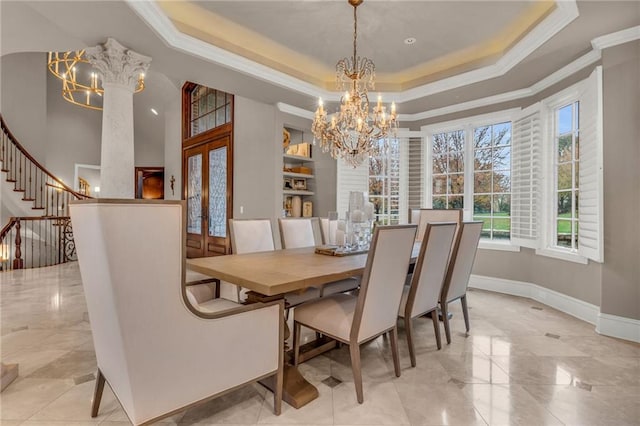 dining room with crown molding, a notable chandelier, french doors, and a tray ceiling