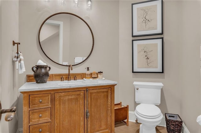 bathroom featuring tile patterned floors, vanity, and toilet