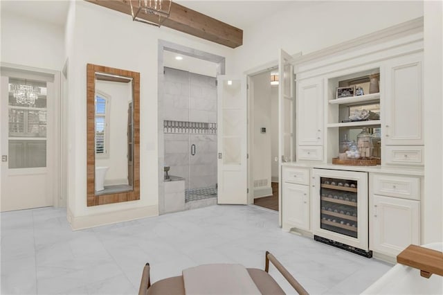 bathroom featuring built in features, a shower with shower door, beam ceiling, and wine cooler