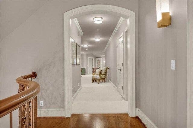 hall with dark hardwood / wood-style floors and crown molding