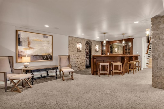 bar featuring carpet flooring and decorative light fixtures