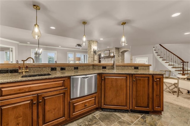 kitchen with pendant lighting, ornamental molding, sink, and dishwasher