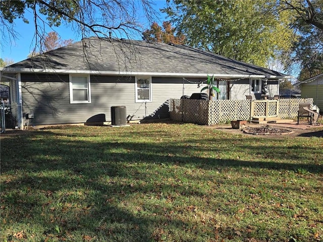 rear view of property featuring a yard