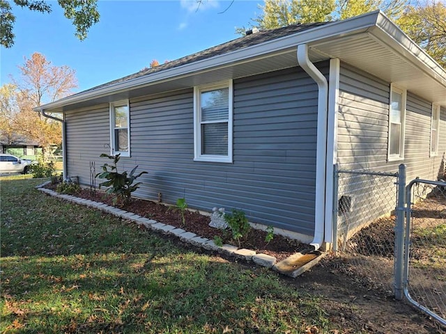 view of side of home featuring a lawn