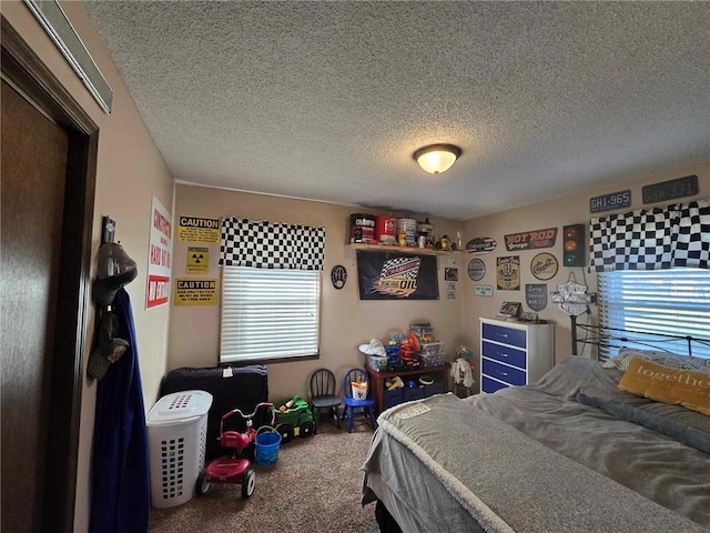 bedroom featuring a textured ceiling and carpet floors