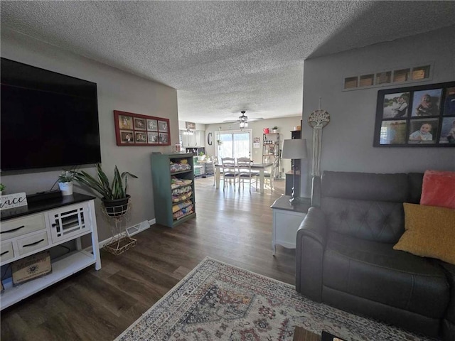 living room featuring a textured ceiling, wood-type flooring, and ceiling fan