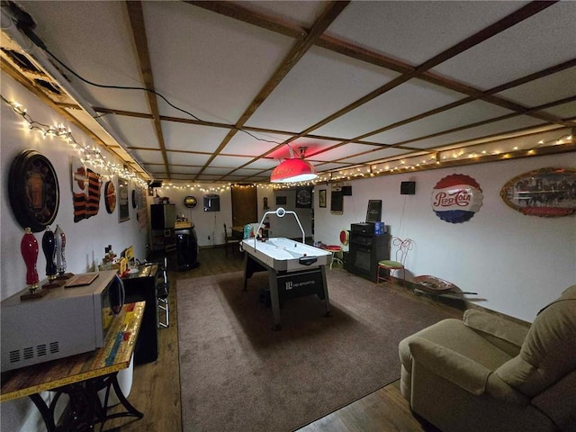 playroom featuring coffered ceiling and hardwood / wood-style floors