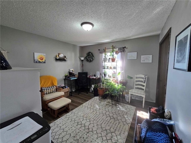 bedroom with dark hardwood / wood-style flooring and a textured ceiling