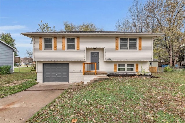 bi-level home with a garage and a front lawn