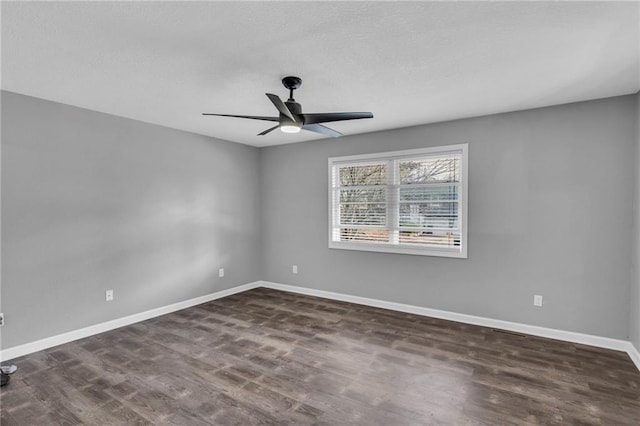 unfurnished room with dark hardwood / wood-style floors and ceiling fan