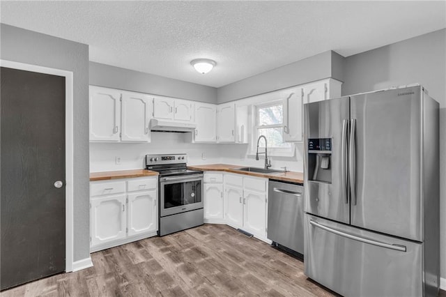 kitchen with appliances with stainless steel finishes and white cabinets