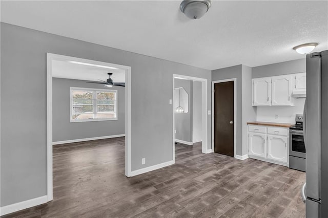 kitchen with white cabinetry, light hardwood / wood-style flooring, ceiling fan, and appliances with stainless steel finishes