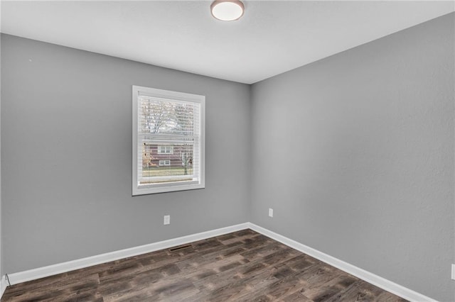 empty room with dark wood-type flooring