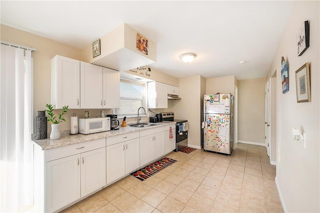 kitchen with white cabinets, light stone counters, sink, and stainless steel appliances