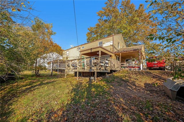 back of house featuring a deck and a yard