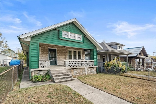 bungalow-style house with a porch and a front yard