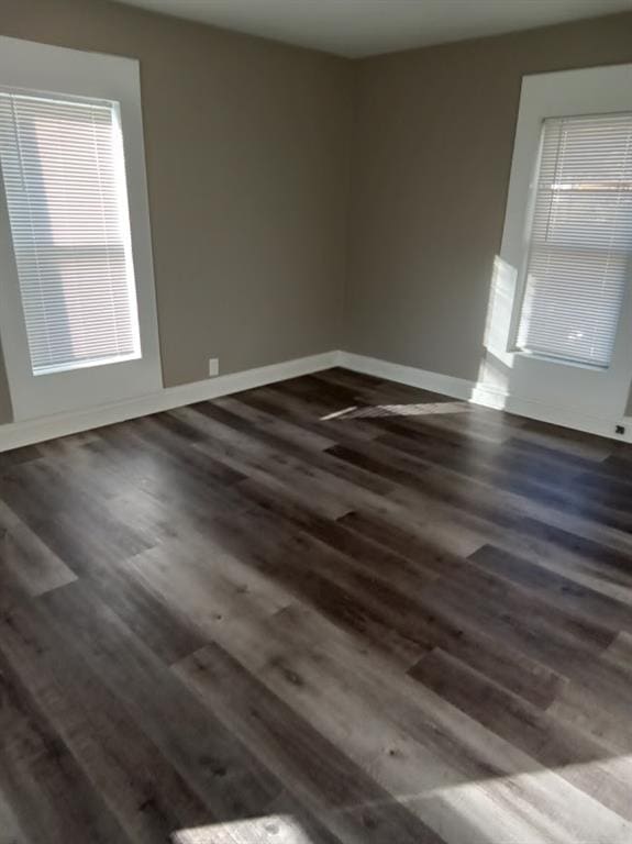 empty room with dark wood-type flooring