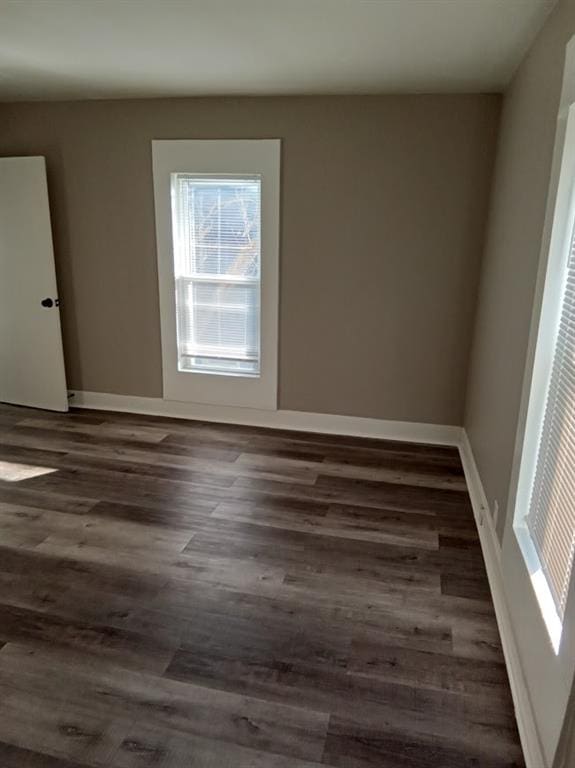 empty room featuring dark hardwood / wood-style flooring