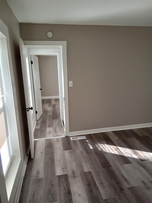 corridor with hardwood / wood-style floors