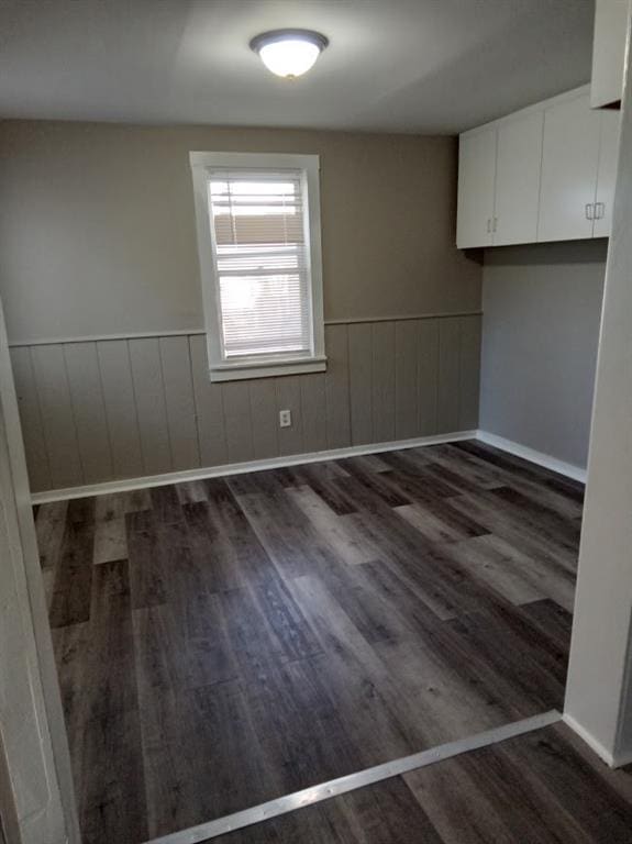 unfurnished dining area featuring dark hardwood / wood-style floors