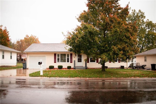 single story home with a front lawn and a garage