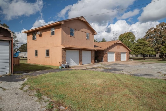 view of side of home with a lawn and a garage