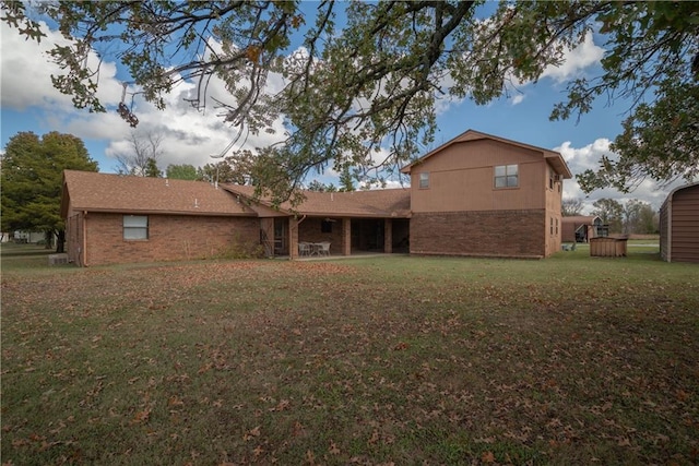 back of property featuring a lawn