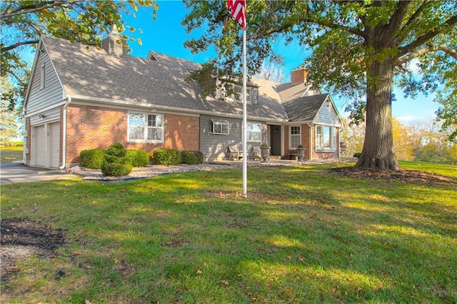 view of front of house with a front yard and a garage