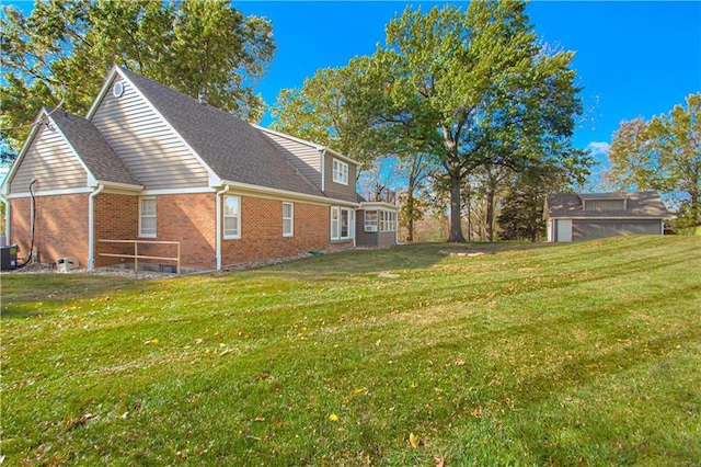 rear view of property featuring central AC, a shed, and a yard