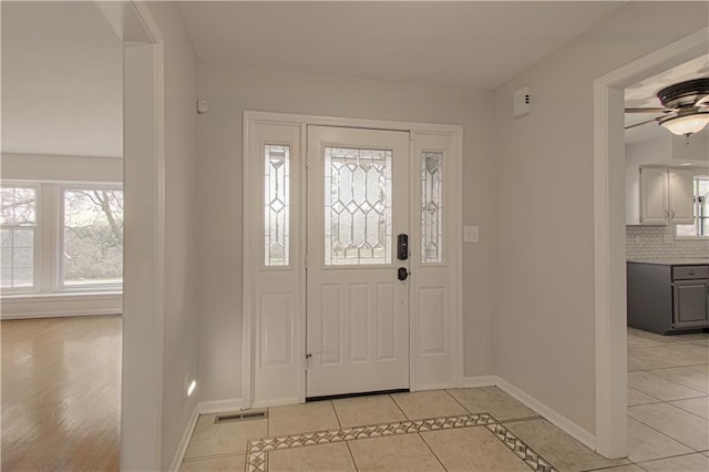 entryway featuring ceiling fan and light tile patterned flooring