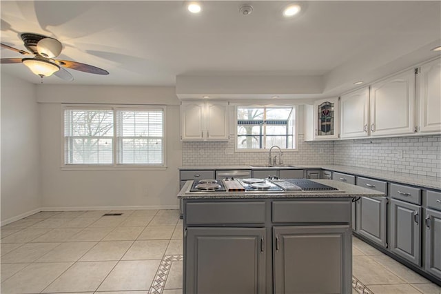 kitchen with white cabinets, sink, gray cabinets, and a kitchen island