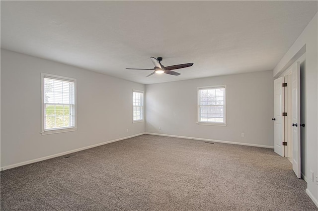 unfurnished room featuring carpet floors, ceiling fan, and a healthy amount of sunlight