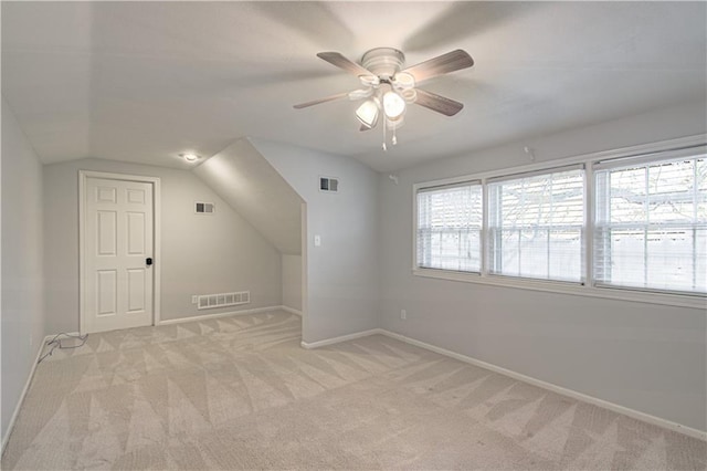 additional living space with light carpet, vaulted ceiling, and ceiling fan