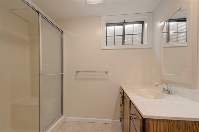 bathroom featuring a shower with shower door, tile patterned floors, and vanity