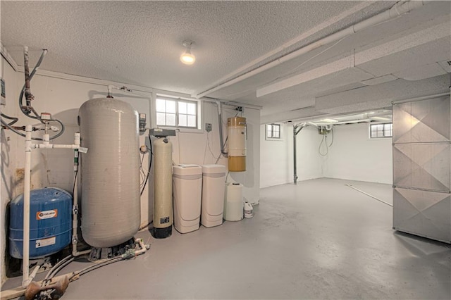 basement with a textured ceiling and heating unit